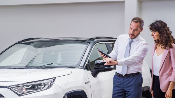 Toyota salesman helping interested customer