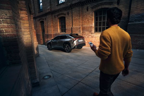 person walking towards a Toyota bZ4X