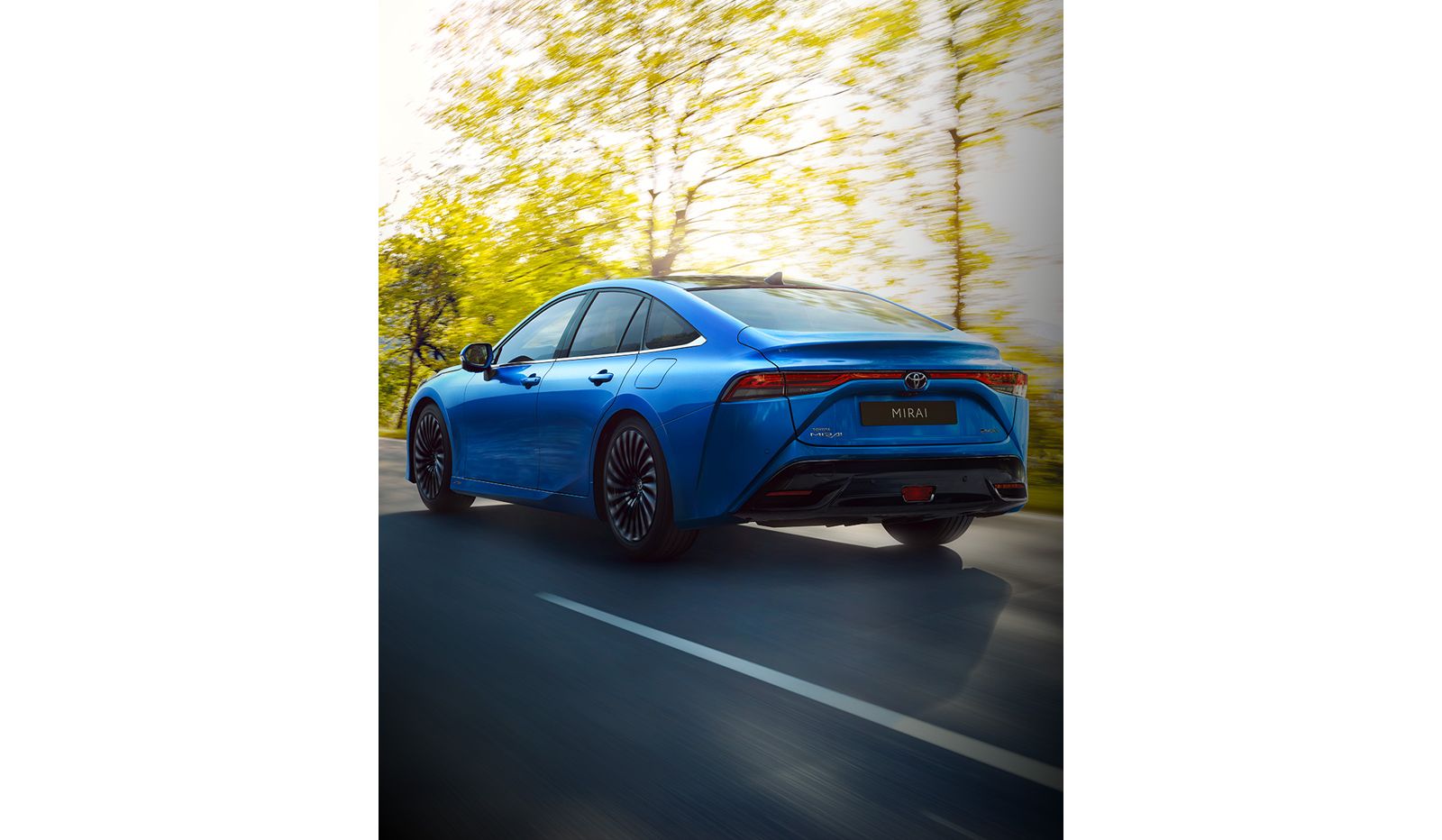Toyota Mirai powers along a beautiful country road 